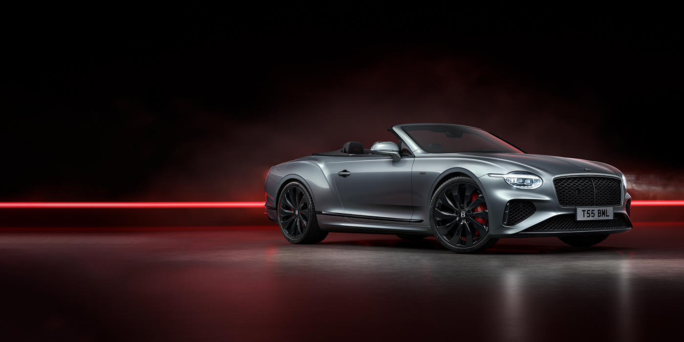 Bentley Lyon Bentley Continental GTC Black Edition convertible front three quarters in Hallmark silver against a dark grey and red background
