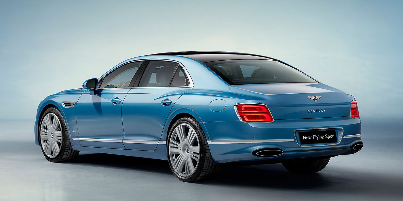 Bentley Lyon New Bentley Flying Spur Azure sedan rear view in Light windsor blue by Mulliner paint with 22 inch Azure wheels and chrome exterior details