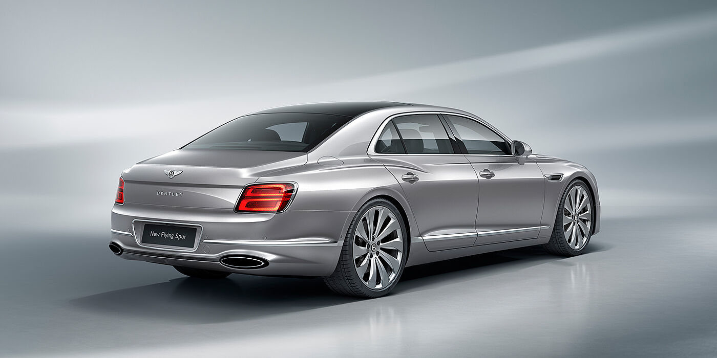 Bentley Lyon New Bentley Flying Spur sedan rear view in Silverlake paint with ten spoke wheels and chrome matrix grille