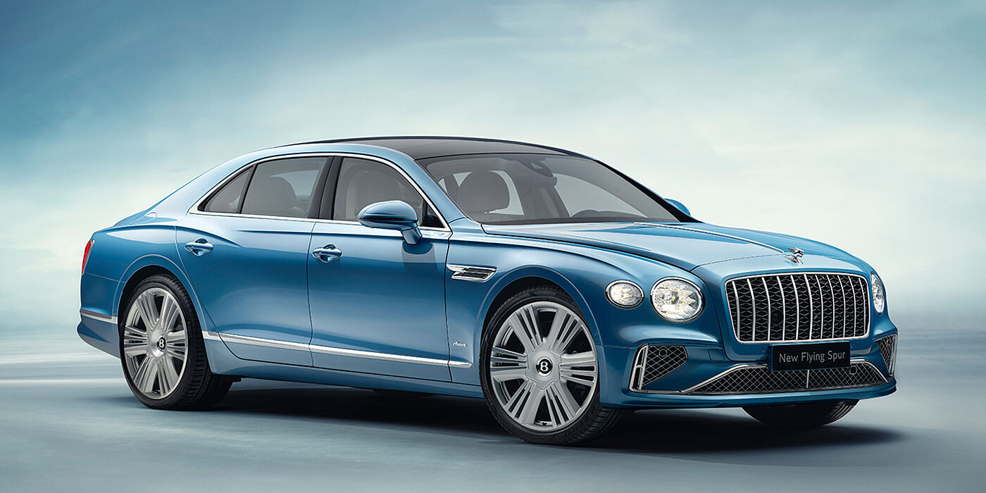 Bentley Lyon New Bentley Flying Spur Azure sedan front view in Light windsor blue by Mulliner paint with 22 inch Azure wheels and chrome exterior details
